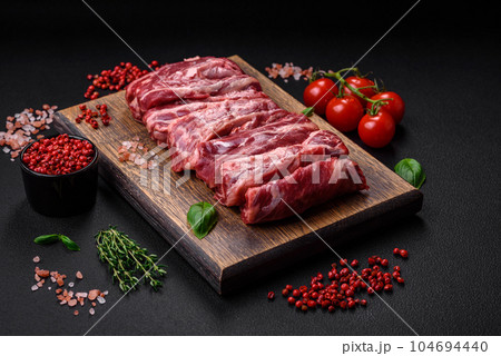 Fresh raw beef ribs with salt, spices and herbs Fresh raw beef ribs with salt, spices and herbs 104694440
