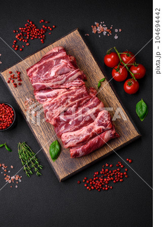 Fresh raw beef ribs with salt, spices and herbs Fresh raw beef ribs with salt, spices and herbs 104694442
