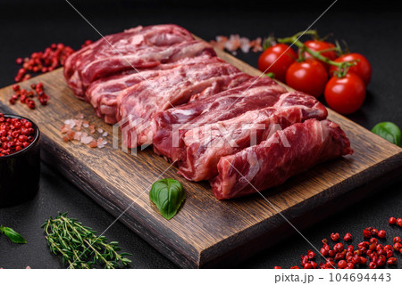 Fresh raw beef ribs with salt, spices and herbs 104694443