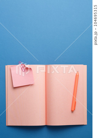 Open notepad with pen, plant and note sheet. Open notepad with pen, plant and note sheet. 104695315