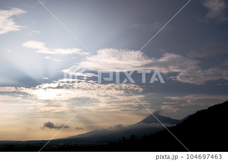 雲の裏から放射状の夕日が放され、シルエットの磐梯山とのコラボレーションが青空に綺麗だ。 104697463