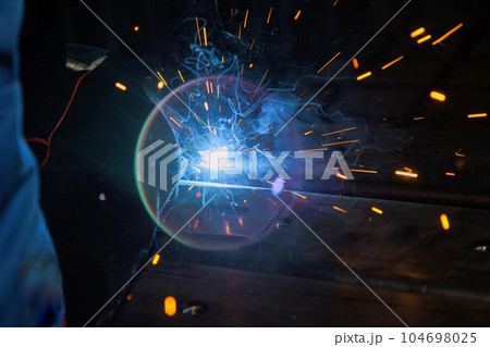Using semi-automatic argon arc welding skilled welder executes precise during welding works. 104698025