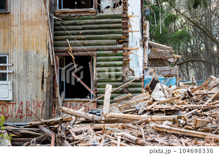 Fragment of the broken wall of an old wooden house 104698336