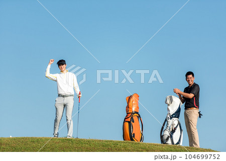 Golfer sport course golf ball fairway.  Group People lifestyle man and friend playing game golf 104699752