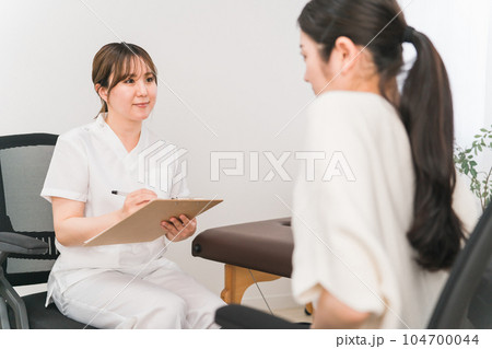 腹痛で悩む女性を診察する医師・整体師(整体・整骨) 腹痛で悩む女性を診察する医師・整体師(整体・整骨) 104700044