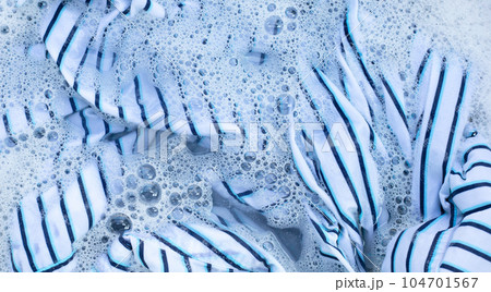 Top view of formal shirts soak in powder detergent water dissolution. Laundry concept 104701567