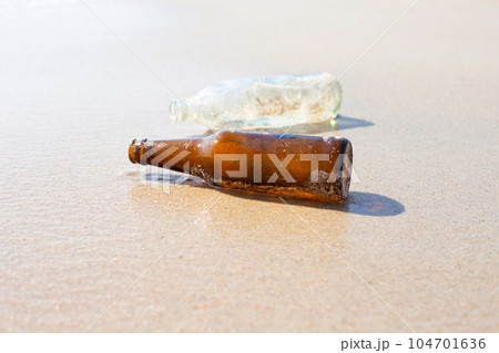 Glass bottles on the beach Glass bottles on the beach 104701636