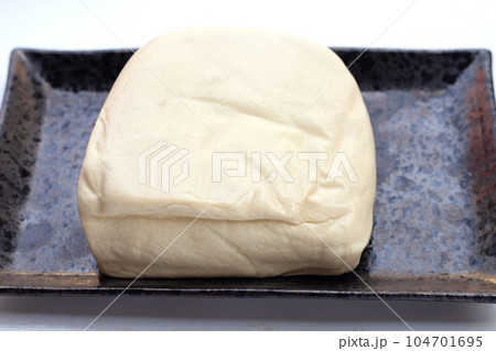 White tofu in black plate on white background White tofu in black plate on white background 104701695