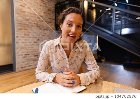 Happy caucasian casual businesswoman making video call in office 104702976
