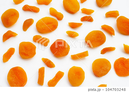Dried apricots on white background. 104703248