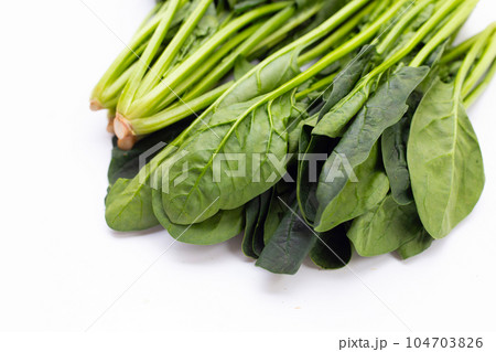 Fresh spinach on white background Fresh spinach on white background 104703826