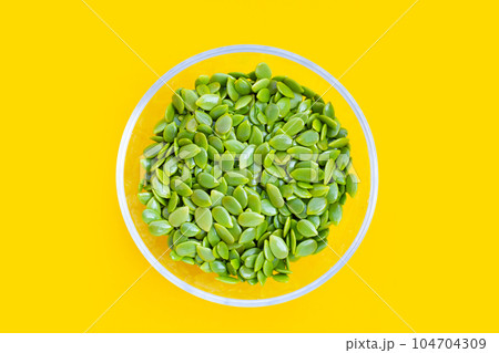 Seeds of leucaena leucocephala on yellow background. Seeds of leucaena leucocephala on yellow background. 104704309