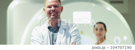 Happy male therapist or mri specialist with patient at clinic 104707190