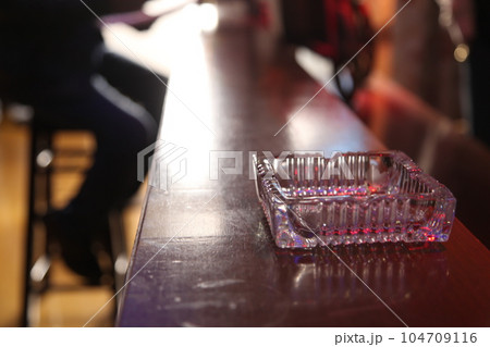 Ash tray on a table 104709116