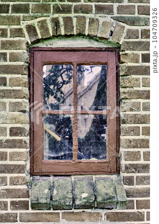 Closeup of an abandoned window covered in spiderwebs from neglect, poverty and economic crisis. Empty, old and dirty residential brick building or home in village with broken frame on the windowsill Closeup of an abandoned window covered in spiderwebs from neglect, poverty and economic crisis. Empty, old and dirty residential brick building or home in village with broken frame on the windowsill 104709326