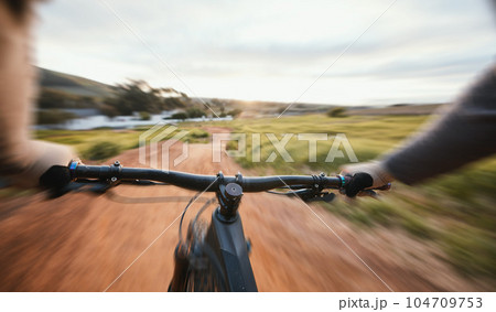 Sports, cycling and person pov on a bike in nature for fitness, training and morning cardio routine. Bicycle, exercise and cyclist riding in countryside with freedom performance or speed challenge 104709753