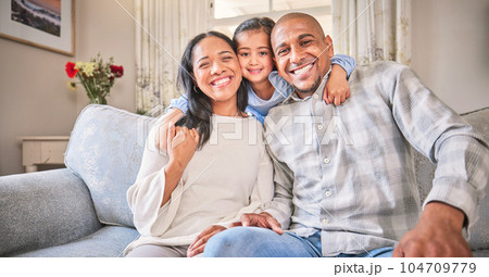 Portrait, family and smile on sofa in home living room, bonding and having fun. Face, parents and happy child, mother and father with love, relax on couch and enjoying quality time together in house. 104709779