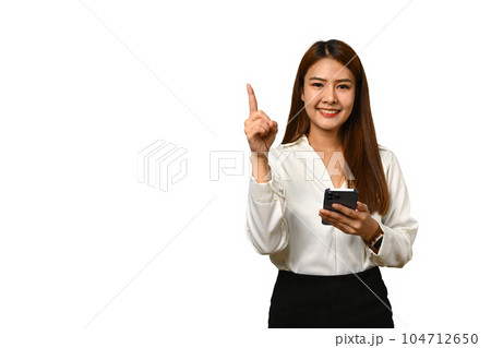 Attractive woman holding mobile phone and pointing aside, shows space for your advertisement or promotional text 104712650