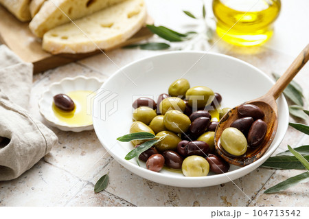 Olives, ciabatta and olive oil in a bottle Olives, ciabatta and olive oil in a bottle 104713542