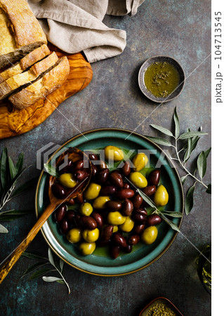 Olives and olive oil, top view Olives and olive oil, top view 104713545