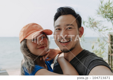 Selfie portrait of lovely and cheerful couple hug and kiss. Selfie portrait of lovely and cheerful couple hug and kiss. 104713871