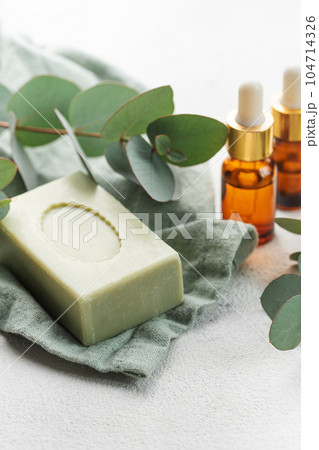 Soap, eucalyptus, aroma essential oil,  spa objects on a concrete background. 104714326
