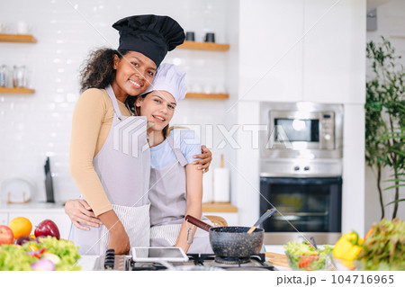 couple woman lover LGBT friend living with love care cooking at home holiday activity together 104716965