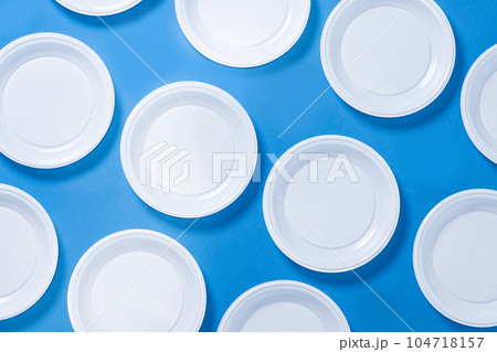Disposable waste plastic on blue background Disposable waste plastic on blue background 104718157
