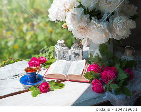 Book and coffee near a bouquet of flowers 104719651