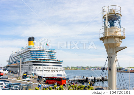 Scenic view big modern cruise liner ship docked at car tourist bus parking Oslo quay Kiel Fjord harbor of Baltic sea in Germany. Ocean cruise line trip passenger terminal. Luxury sea travel adventure Scenic view big modern cruise liner ship docked at car tourist bus parking Oslo quay Kiel Fjord harbor of Baltic sea in Germany. Ocean cruise line trip passenger terminal. Luxury sea travel adventure 104720101