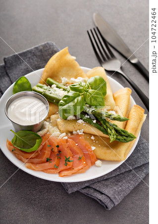 Savory crepes with salmon, sour cream and asparagus Savory crepes with salmon, sour cream and asparagus 104722464