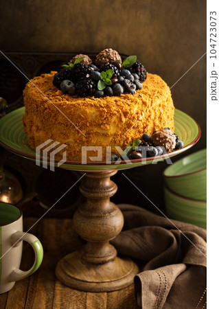 Honey layered cake with candy and berry Honey layered cake with candy and berry 104723073