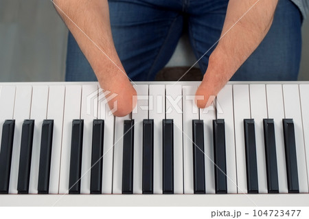 Man with physical disability amputated two hands musician is playing the piano. Man with physical disability amputated two hands musician is playing the piano. 104723477