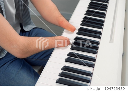 Man with physical disability amputated two hands musician is playing the piano. 104723480