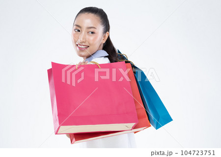 Beautiful Attractive Asian Woman smile and holding shopping bags feeling so happiness and enjoy with black Friday sale in Shopping mall,isolated on white background. Shopping Lifestyle Concept 104723751