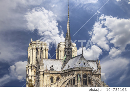 Notre Dame de Paris (against the background of sky with clouds), also known as Notre Dame Cathedral or simply Notre Dame, is a Gothic, Roman Catholic cathedral of Paris, France 104725168
