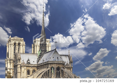 Notre Dame de Paris (against the background of sky with clouds), also known as Notre Dame Cathedral or simply Notre Dame, is a Gothic, Roman Catholic cathedral of Paris, France 104725169