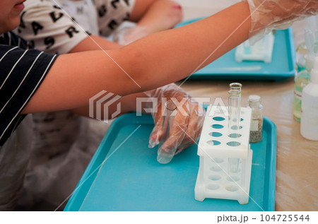 kids in science lab study using pipette dropping liquid to test tube , caucasian , biochemistry . chemistry class kids in science lab study using pipette dropping liquid to test tube , caucasian , biochemistry . chemistry class 104725544