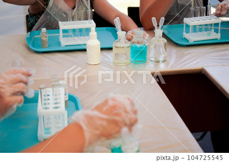 kids in science lab study using pipette dropping liquid to test tube , caucasian , biochemistry . chemistry class kids in science lab study using pipette dropping liquid to test tube , caucasian , biochemistry . chemistry class 104725545