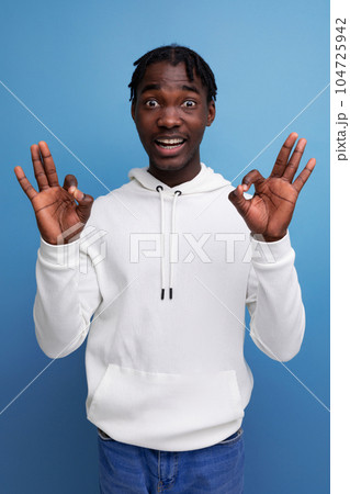 puzzled dark-skinned young brunette male in studio isolated background 104725942