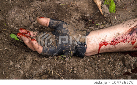 Hand of a wounded soldier covered in blood 104726376