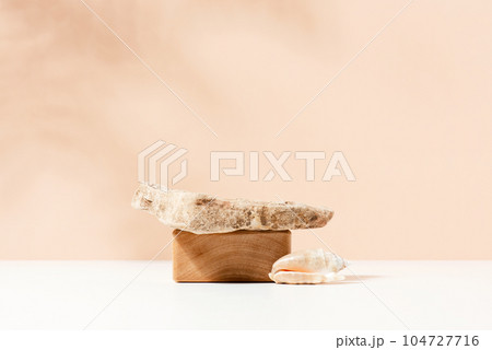 Natural background with wooden block, stone and seashell. Podium for cosmetics presentation 104727716