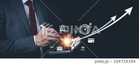 2023 and Startup concept with icon business and network connection on modern virtual interface from digital tablet.Businessman Touching tablet and graph Screen Icon of media screen, Technology Process 2023 and Startup concept with icon business and network connection on modern virtual interface from digital tablet.Businessman Touching tablet and graph Screen Icon of media screen, Technology Process 104728384