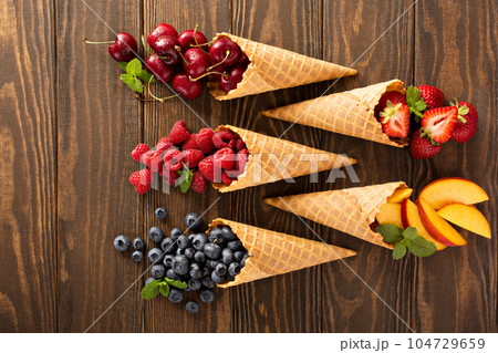 Fresh fruit and berries in waffle cones 104729659