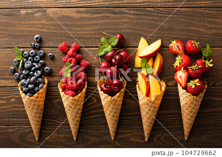 Fresh fruit and berries in waffle cones Fresh fruit and berries in waffle cones 104729662