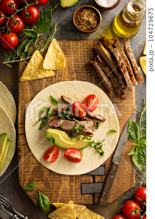 Making tacos with grilled steak Making tacos with grilled steak 104729675