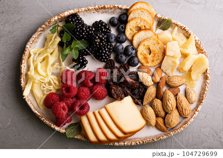 Cheese plate with nuts and berries Cheese plate with nuts and berries 104729699