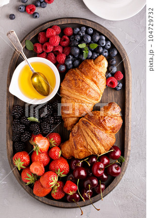 Healthy breakfast with freshly baked croissants and berries Healthy breakfast with freshly baked croissants and berries 104729732