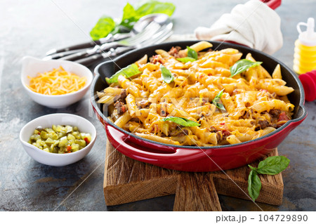 Cheesy pasta bake with ground beef and herbs Cheesy pasta bake with ground beef and herbs 104729890