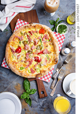 Breakfast pizza with scrambled egg, ham and tomatoes Breakfast pizza with scrambled egg, ham and tomatoes 104730407